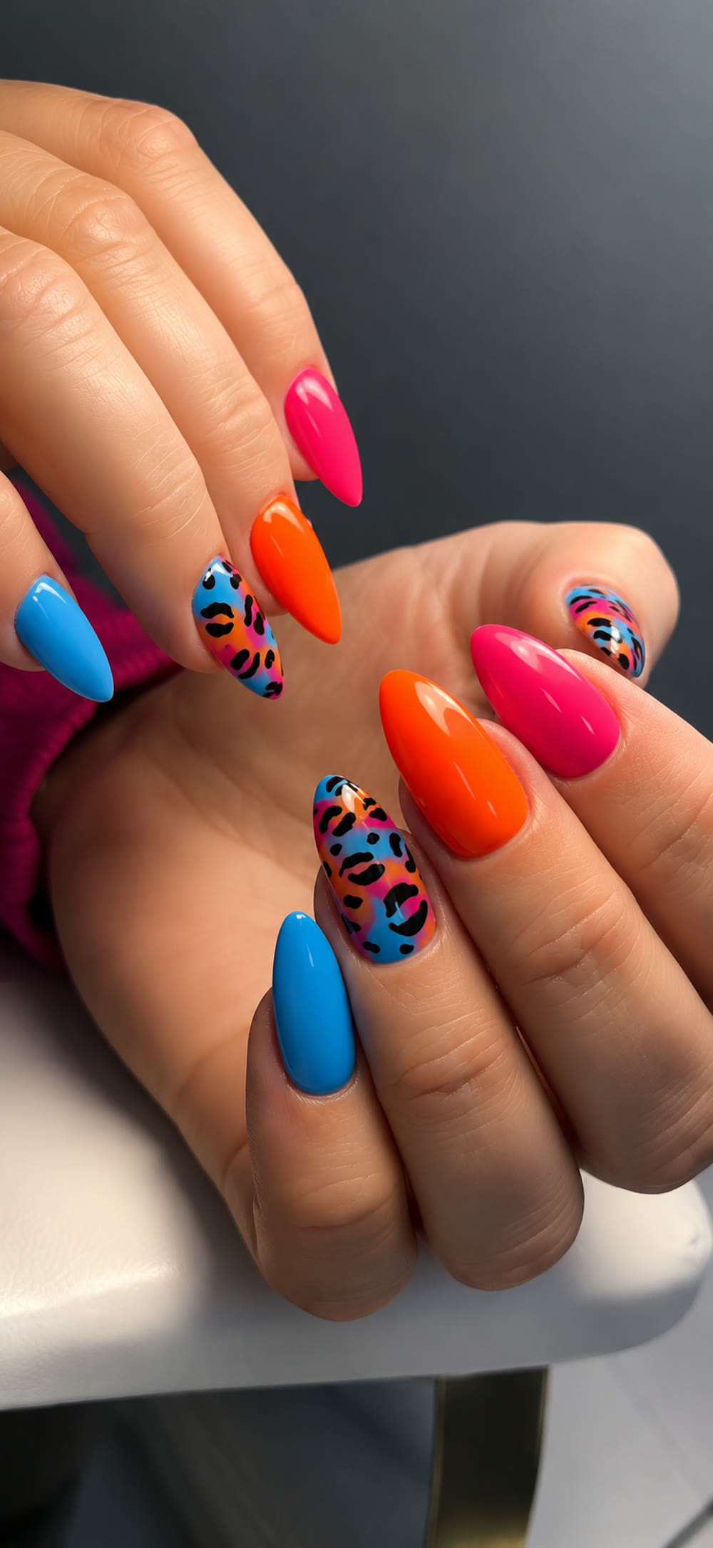 Vivid pink, orange and blue manicure with playful leopard accents.