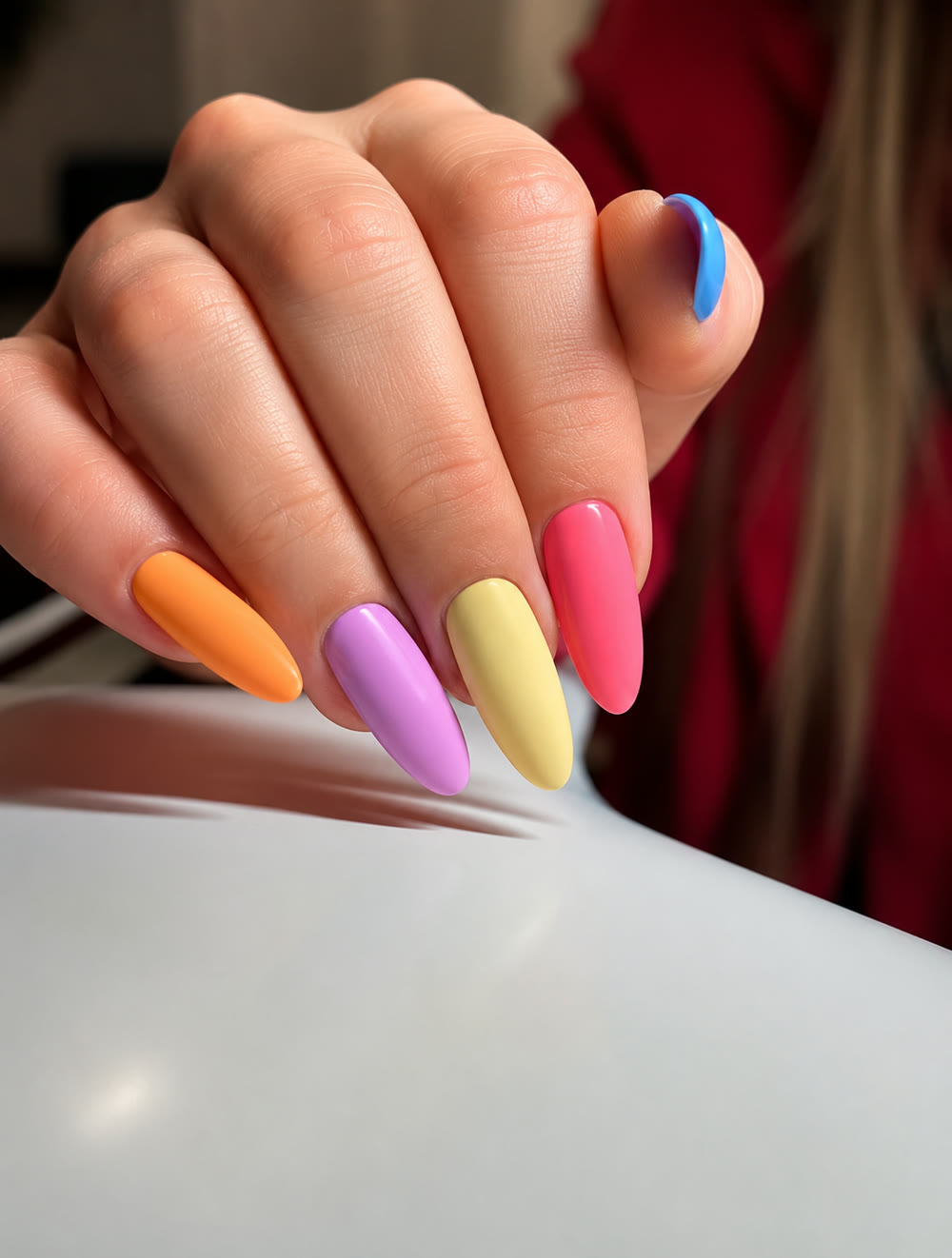 Pastel multi-colour manicure in orange, lilac and blue.