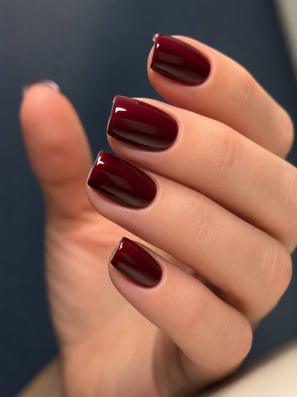 Deep burgundy square nails with a mirror-gloss finish.